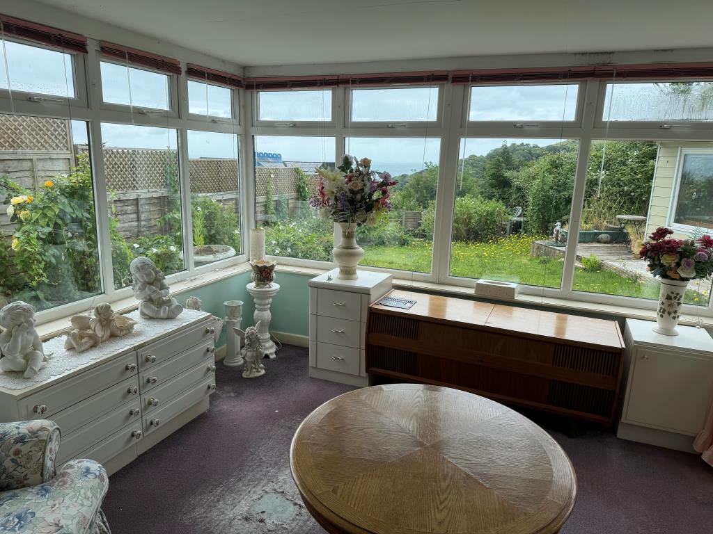 Lot: 93 - HOUSE FOR IMPROVEMENT ON SOUGHT AFTER PRIVATE ESTATE - The Sun Room overlooking the rear garden
